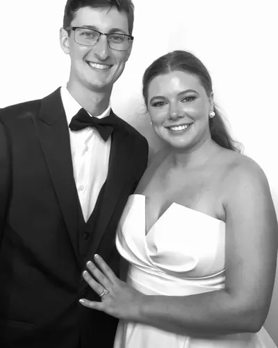 A bride and groom photographed in black and white in the booth