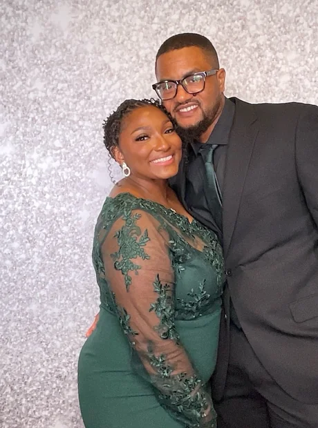 A couple in formalwear photographed at the booth during a charity ball