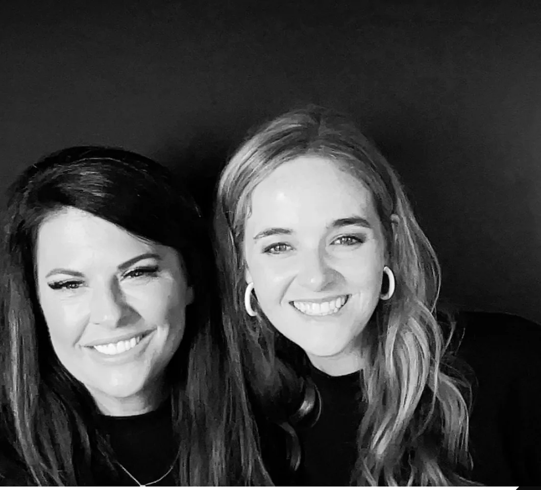 Two guests photographed in black and white in the booth